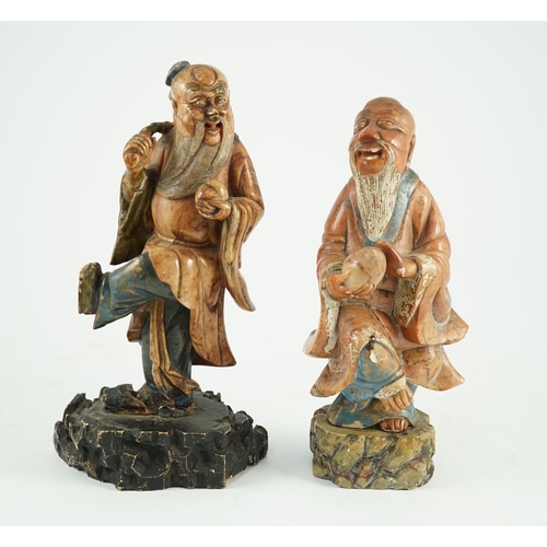 155 - Two Chinese soapstone figures of Shou Lao, 18th century, each figure holding a peach and standing on... 