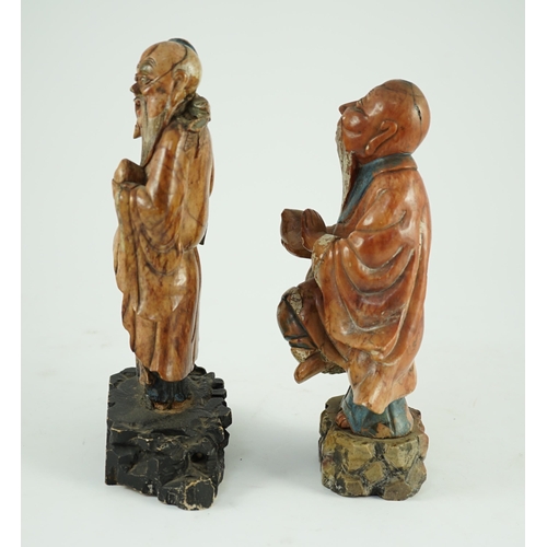 155 - Two Chinese soapstone figures of Shou Lao, 18th century, each figure holding a peach and standing on... 