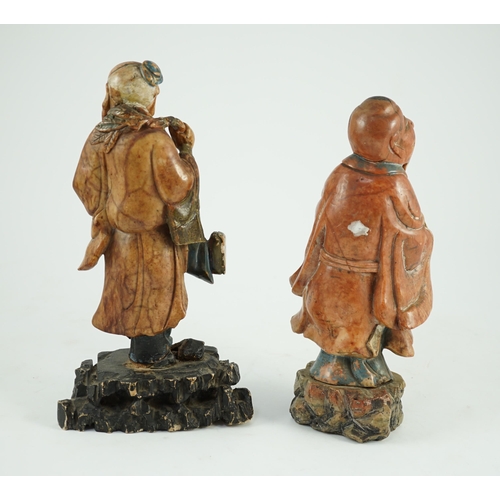 155 - Two Chinese soapstone figures of Shou Lao, 18th century, each figure holding a peach and standing on... 