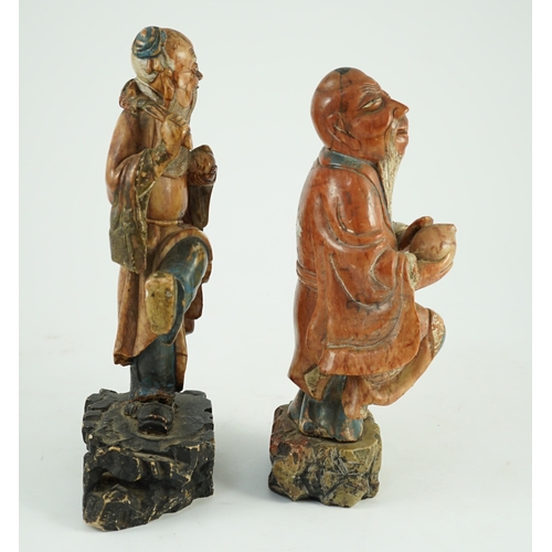 155 - Two Chinese soapstone figures of Shou Lao, 18th century, each figure holding a peach and standing on... 