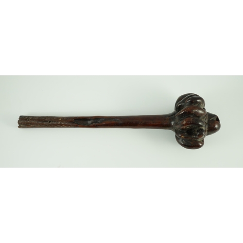 16 - A Fijian hardwood throwing club, with zig-zag relief carved handle and further irregular spotted dec... 