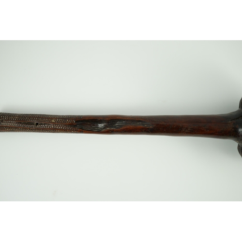 16 - A Fijian hardwood throwing club, with zig-zag relief carved handle and further irregular spotted dec... 