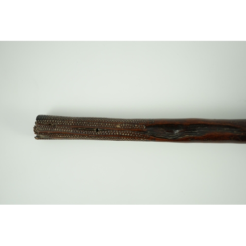 16 - A Fijian hardwood throwing club, with zig-zag relief carved handle and further irregular spotted dec... 