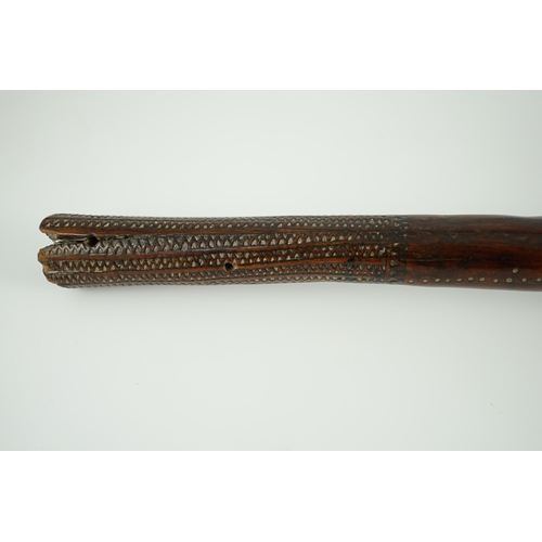 16 - A Fijian hardwood throwing club, with zig-zag relief carved handle and further irregular spotted dec... 