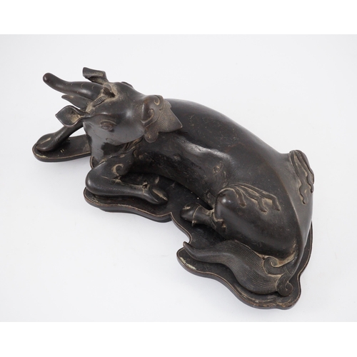 163 - A Chinese bronze figure of a recumbent qilin, late Ming dynasty, Campbell collection label to base, ... 