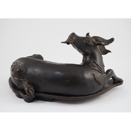 163 - A Chinese bronze figure of a recumbent qilin, late Ming dynasty, Campbell collection label to base, ... 