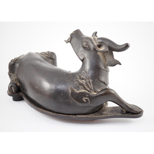 163 - A Chinese bronze figure of a recumbent qilin, late Ming dynasty, Campbell collection label to base, ... 