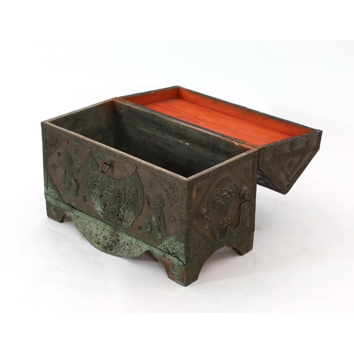 164 - A Tibetan copper repousse-work casket, 20th century, the arched cover and side panels decorated with... 