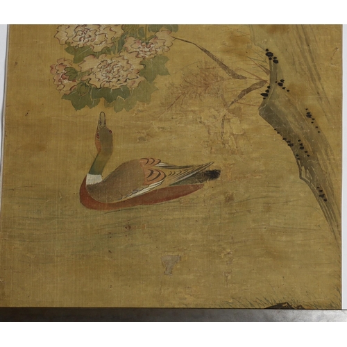 169 - A Chinese scroll painting on silk of birds, rockwork and plants overhanging a pond, 19th century, in... 