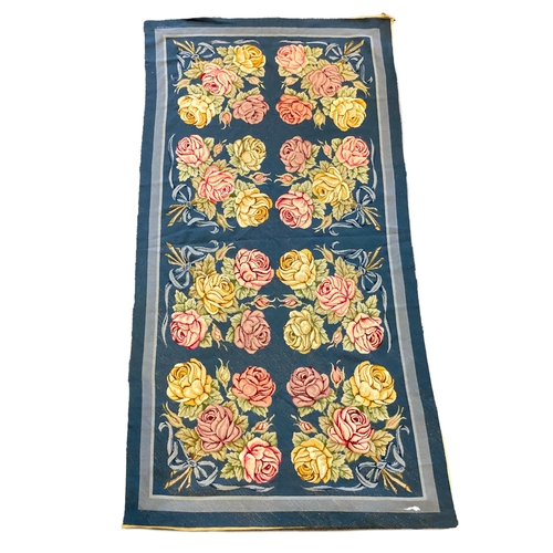 197 - An English needlepoint blue ground carpet, woven with polychrome rose bunches, initialled and dated ... 