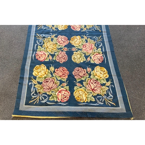 197 - An English needlepoint blue ground carpet, woven with polychrome rose bunches, initialled and dated ... 