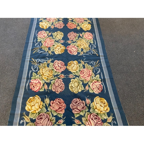 197 - An English needlepoint blue ground carpet, woven with polychrome rose bunches, initialled and dated ... 