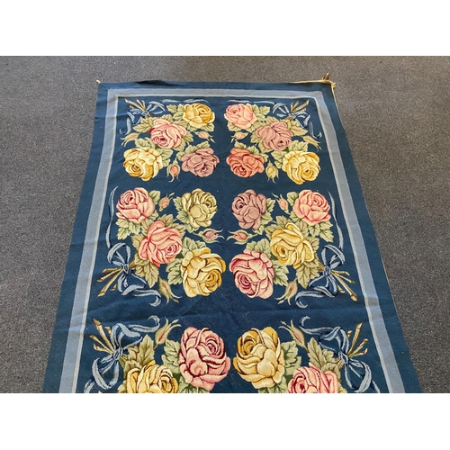 197 - An English needlepoint blue ground carpet, woven with polychrome rose bunches, initialled and dated ... 