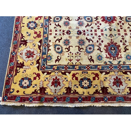 199 - An Agra ivory ground carpet, with stylised floral field within a wide conforming border, 360 x 274cm... 