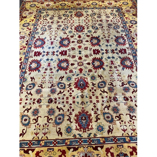 199 - An Agra ivory ground carpet, with stylised floral field within a wide conforming border, 360 x 274cm... 