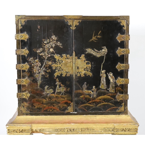 206 - A William & Mary black japanned cabinet on stand, the two door cabinet with original gilt brass moun... 