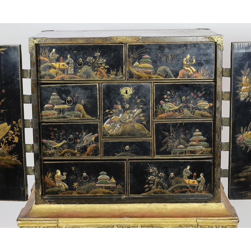 206 - A William & Mary black japanned cabinet on stand, the two door cabinet with original gilt brass moun... 