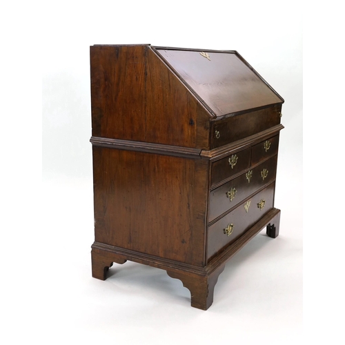 209 - An early 18th century burr walnut bureau, the fall enclosing a central cupboard door flanked by an a... 