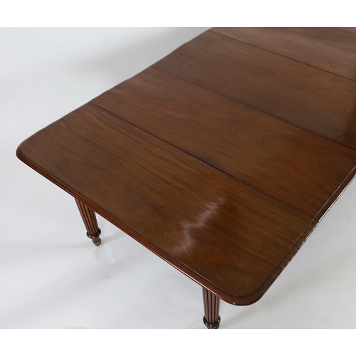 216 - A Regency mahogany extending dining table, with rounded rectangular top and four leaves, on six turn... 