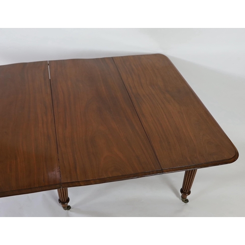 216 - A Regency mahogany extending dining table, with rounded rectangular top and four leaves, on six turn... 