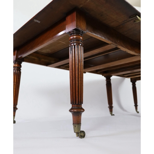 216 - A Regency mahogany extending dining table, with rounded rectangular top and four leaves, on six turn... 