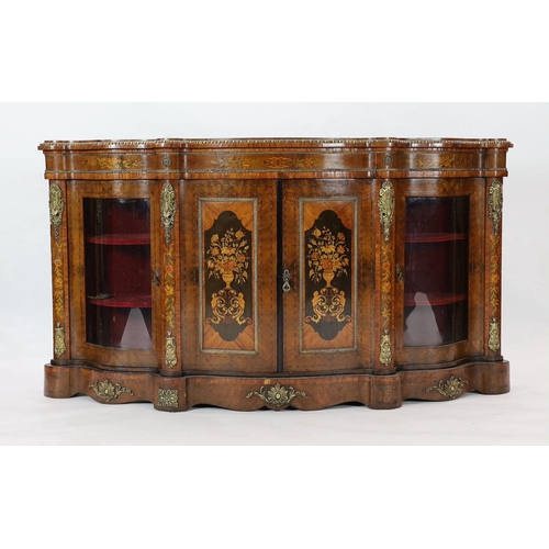 224 - A Victorian marquetry inlaid walnut serpentine front credenza, the two central doors inlaid with pan... 