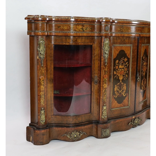 224 - A Victorian marquetry inlaid walnut serpentine front credenza, the two central doors inlaid with pan... 