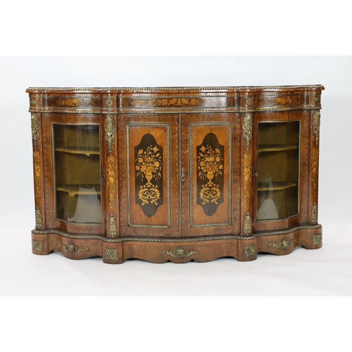 225 - A Victorian marquetry inlaid walnut serpentine credenza, with ormolu mounts and floral marquetry pan... 