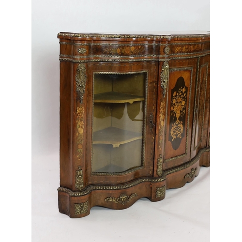 225 - A Victorian marquetry inlaid walnut serpentine credenza, with ormolu mounts and floral marquetry pan... 