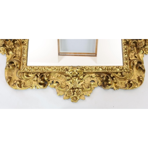 227 - A mid 19th century Florentine ornately carved giltwood wall mirror, of rectangular cartouche form wi... 