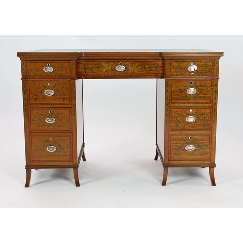 229 - An Edwardian painted satinwood kneehole desk, with concave front and bowed back and decorated in the... 