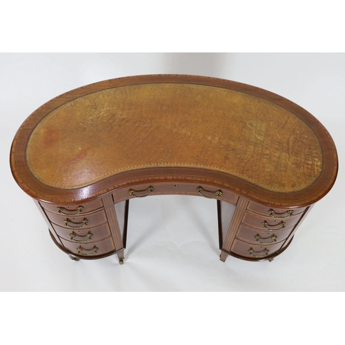 230 - An Edwardian satinwood banded mahogany kidney shaped kneehole desk, with brown skiver and arrangemen... 