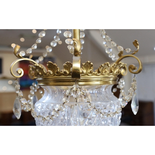 231 -  A late Victorian ormolu and cut glass light fitting, by F & C Osler, with glass swagged stem, scrol... 