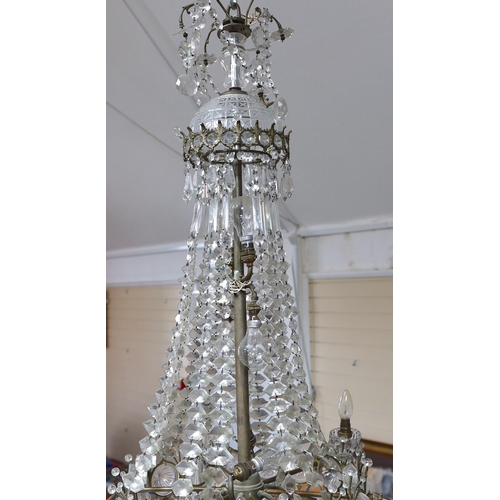 232 - An Edwardian cut glass chandelier, with swagged top and lozenge shaped drops sweeping down to the ma... 