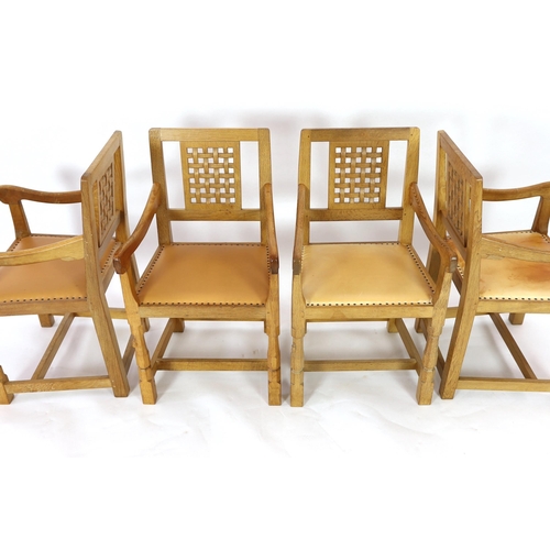 234 - A set of four Robert Thompson 'Mouseman' oak armchairs With carved latticework splats plain arms and... 