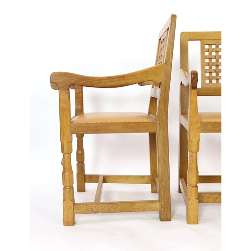 234 - A set of four Robert Thompson 'Mouseman' oak armchairs With carved latticework splats plain arms and... 