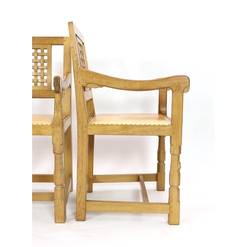 234 - A set of four Robert Thompson 'Mouseman' oak armchairs With carved latticework splats plain arms and... 