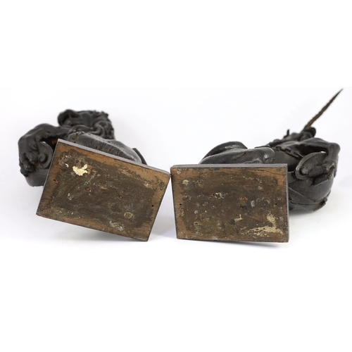 25 - A pair of 18th century carved and ebonised oak heraldic beasts, lion and unicorn, each holding scrol... 