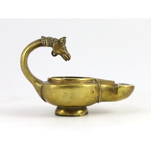 34 - A Renaissance or Roman bronze oil lamp, the high looped handle with horse head finial, 17.5cm long... 