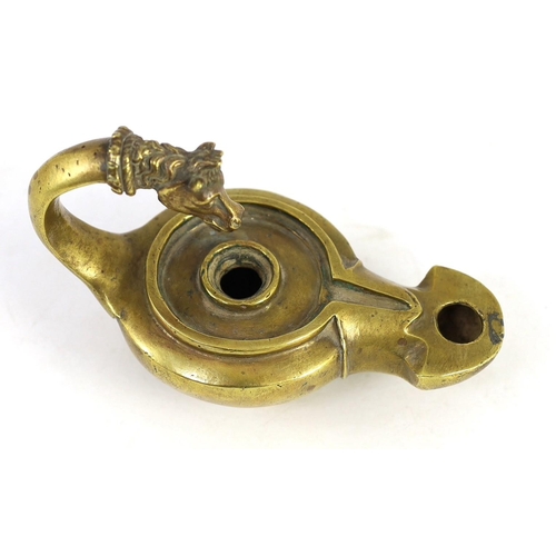 34 - A Renaissance or Roman bronze oil lamp, the high looped handle with horse head finial, 17.5cm long... 