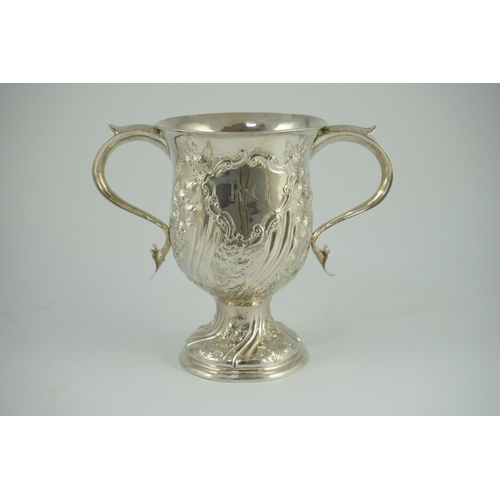 351 - A George III silver baluster two handled pedestal cup, with later embossed decoration, by John Scofi... 