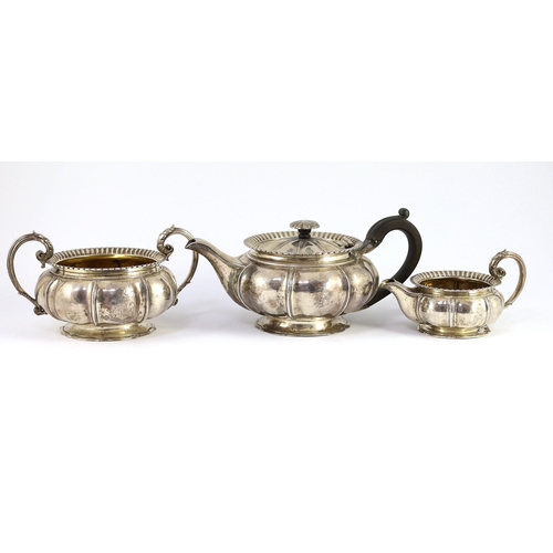 352 - A George IV silver three piece tea set by Benjamin Smith III, of squat melon form, with ornate engra... 