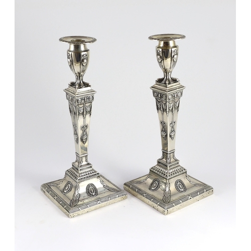 362 - An ornate pair of late Victorian silver candlesticks by Mappin Bros., with waisted square columns an... 