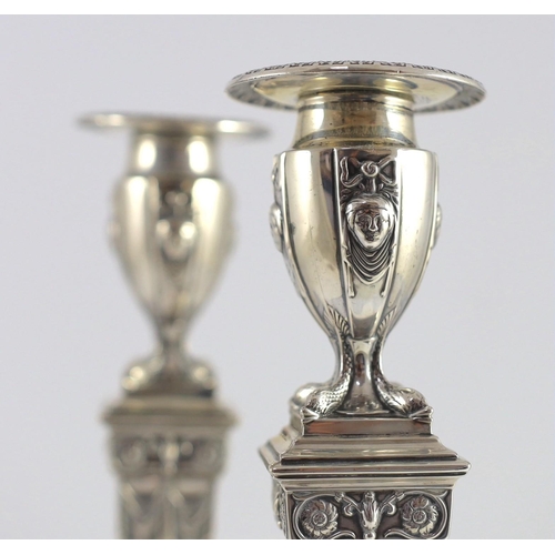 362 - An ornate pair of late Victorian silver candlesticks by Mappin Bros., with waisted square columns an... 