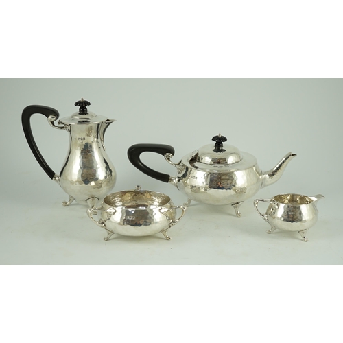 367 - A George V Arts and Crafts three piece planished silver tea set  and a similar hot water pot, by Cha... 