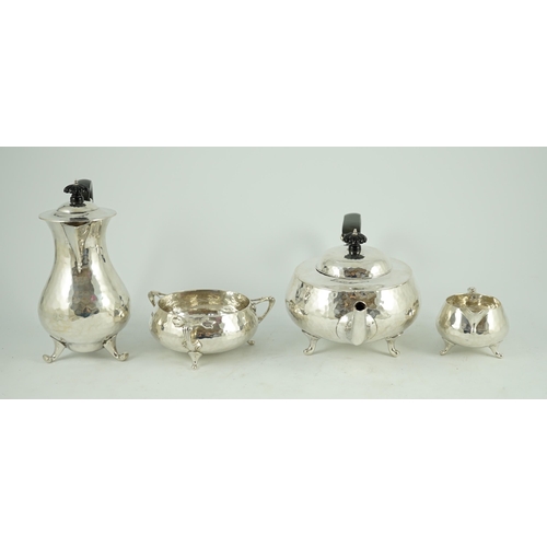 367 - A George V Arts and Crafts three piece planished silver tea set  and a similar hot water pot, by Cha... 