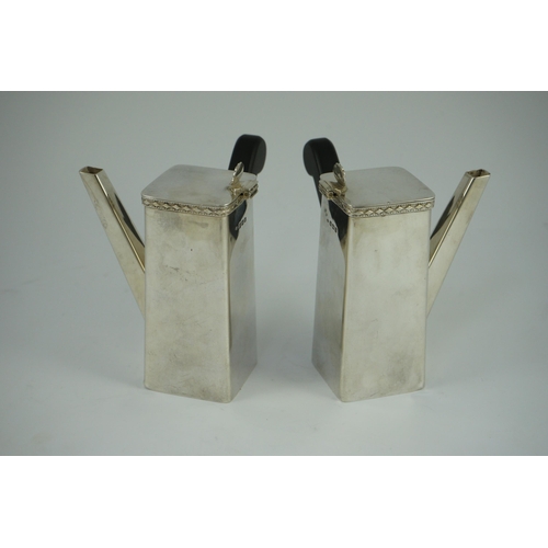 370 - A stylish pair of George V silver cafe au lait pots, by Bert Gordon, of tapering square form with eb... 