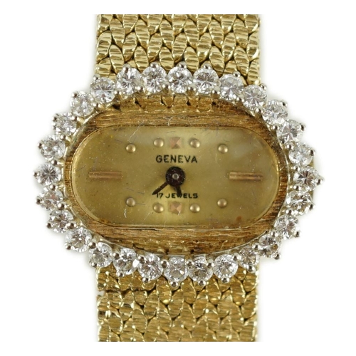 389 - A lady's modern Swiss 14k gold and diamond set manual wind oval wrist watch, on integral 14k gold br... 