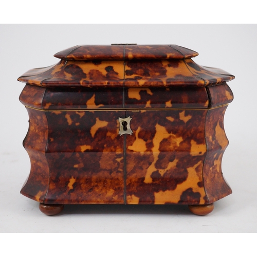 39 - A Regency blond tortoiseshell sarcophagus shaped tea caddy, of octagonal form, with ivory inner band... 