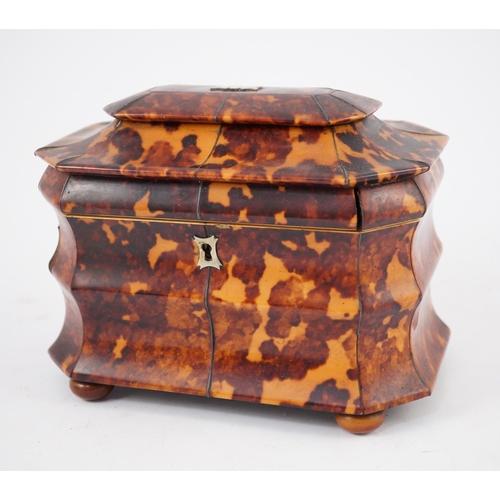 39 - A Regency blond tortoiseshell sarcophagus shaped tea caddy, of octagonal form, with ivory inner band... 